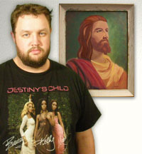 Gerard Gabriel stands in front of a painting that he says contains the image of Jesus Christ.