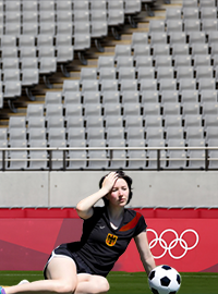 A player for the German Women's Soccer team rests after playing for one minutes.