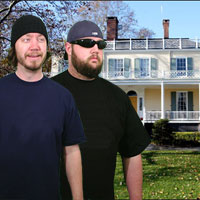 The Lehman brothers pose in front of their large home which was purchased on credit.