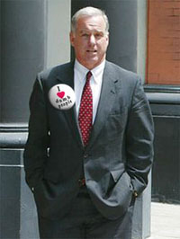 Democratic nominee hopeful Howard Dean wears a "I love dumb people" button to show support for the average American.