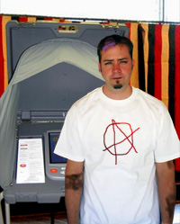 Jerold "Skinner" Watoski exits a voting booth after writing the name of the rock band Good Charlotte on his ballot.
