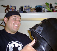 Star Wars fan Ryan Noster reminisces while holding his replica Darth Vader helmet.
